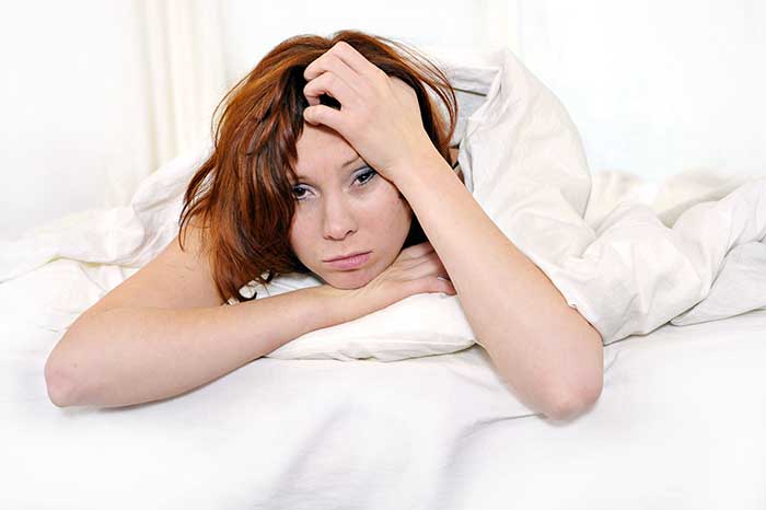 Woman waking up from bed