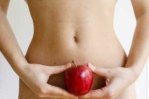 A person holding an apple