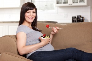 A pregnant girl eating sweets