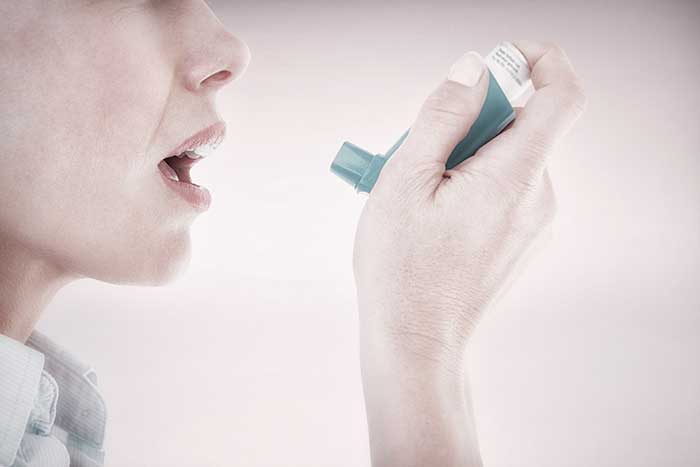 Asthma patient inhaling air from pump