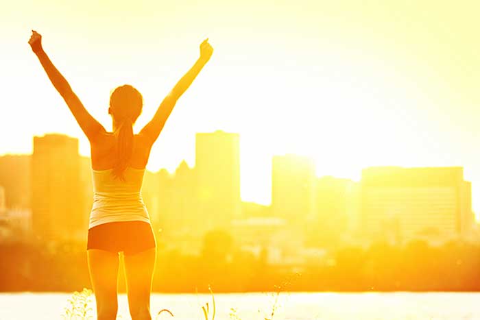 Woman standing in a sunlight