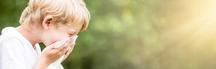 A boy is sneezing