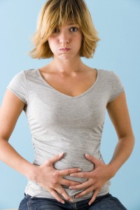 A girl in pain holding her stomach