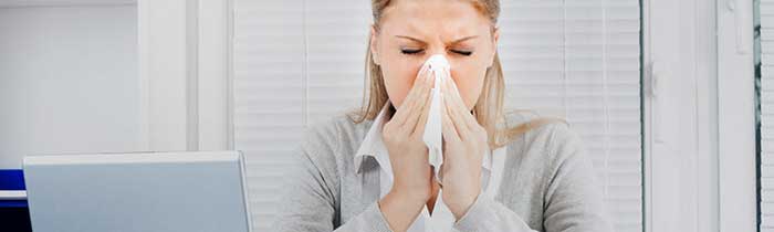 woman suffering from cold in the office