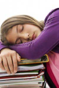 A girl sleeping on books